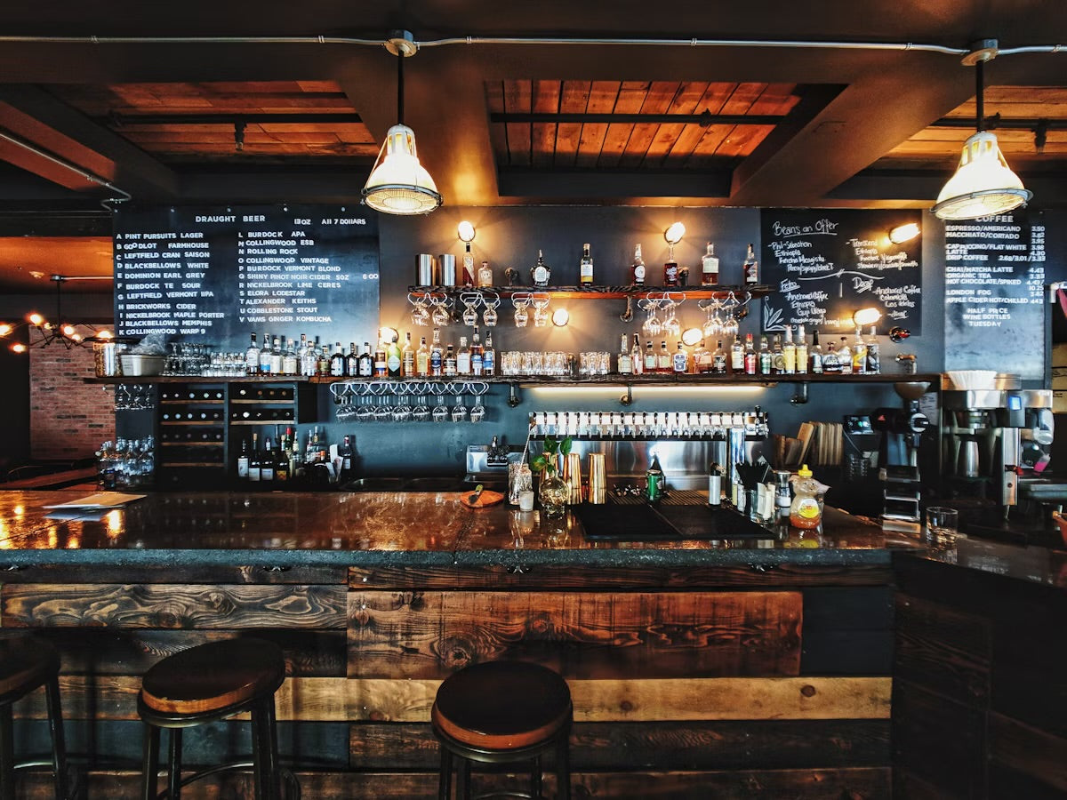 A well-stocked bar highlighting drink spiking awareness with various beverages in a cozy setting.
