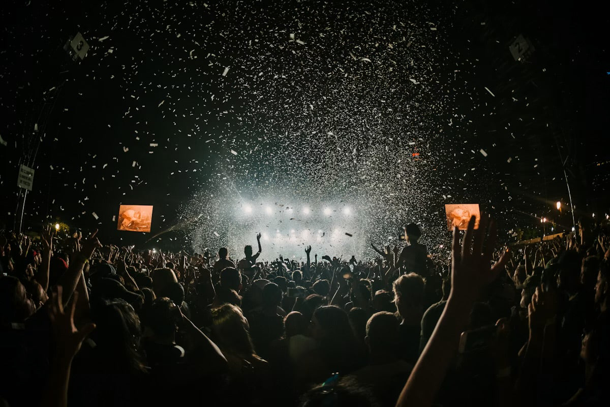 Crowd enjoying a festival with confetti, highlighting the importance of an event safety checklist.